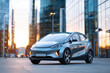 © Alina - Modern electric car in urban sunset
