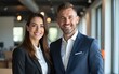 © wang - Portrait of smiling business man and woman standing in contemporary office, professional setting. High quality