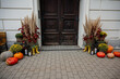 © farmuty - Front door decorated for autumn with pumpkins, gourds, colorful flowers, pampas grass, lanterns, yellow rain boots and rustic fall arrangements creating a cozy welcome