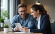 © li - Professional business people, two happy busy mid age business man and young woman executives partners team working together consulting and collaborating sitting in company office using digital tablet.