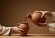 © 5 Grace Media - Hands in robes pour red liquid from an earthenware jug into a second jar against a brown background