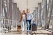 © Anastasiya - Smiling mature couple walking at airport with luggage, arm in arm