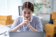 © Wasana - Asian female entrepreneur managing her online business from home office