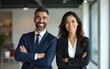 © ning - Happy confident professional mature Latin business man and Asian business woman corporate leaders managers standing in office, two diverse colleagues executives team posing arms crossed, portrait.