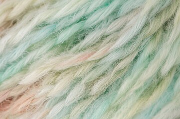  Close-up of vibrant yarn strands on a plain backdrop