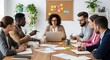 © STRM DESIGNER - Diverse team collaborates around a table in a modern office setting discussing ideas