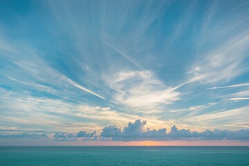 Wall Mural - as the sun dips below the horizon, the sky fills with breathtaking clouds over the ocean.