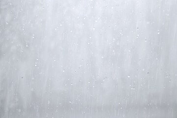 Wall Mural - Water droplets slid down an unpainted surface, tracing lengthy paths as they moved.