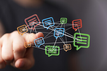 A hand interacts with a network of connected speech bubbles, representing digital communication, messages and network concept.