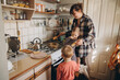 © dsheremeta - Mother preparing breakfast for her children in kitchen