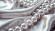© Elena - Close-up of lustrous white pearls on soft satin fabric. The scene conveys elegance and luxury, suitable for celebrations and special occasions.