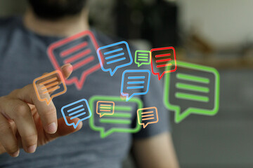 Close up of hand touching 3D rendered digital chat bubbles, concept for social media, communication and global network connection.