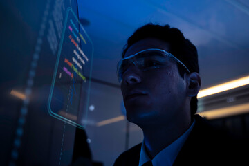 Two software developers collaborating at night, focusing on code review and debugging process on a computer screen, representing teamwork, innovation, and modern software development workflow.