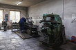 © Northern life - A man is diligently working on a complex machine in a factory setting