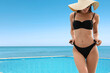 © New Africa - Beautiful woman near swimming pool with view on ocean