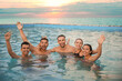 © New Africa - Group of friends resting in swimming pool with view on ocean