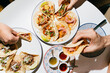 © Mal de Ojo Studio/Stocksy - People Enjoying Delicious Mexican Tacos