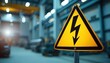 © Viktor - Yellow warning sign displays electric symbol indicating high voltage danger in industrial setting. Workers must observe safety protocols, follow established procedures to prevent electrical hazards.