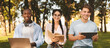 © Prostock-studio - Preparing for lectures. Happy multiracial students studying together outdoors, using laptop, digital tablet and book, sitting on bench in park and smiling at camera