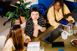 © Adrian Rodd/Stocksy - Female entrepreneurs chatting cheerfully during a work meeting