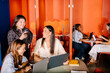 © Adrian Rodd/Stocksy - Different work teams in an office at a digital company
