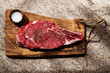 © Vera Lair/Stocksy - Freshly Cut Ribeye Steak on Wooden Board Ready for Cooking