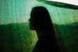© Lucia Postike/Stocksy - Person Silhouetted Against Green Backdrop at Sunset