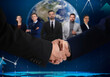 © New Africa - Business partners shaking hands against group of people. Globe and graph on background
