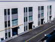 © Yic Ma/Stocksy - Modern warehouse building exterior with loading docks