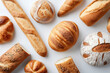 © Vitalii - Selection of various bread types on a white background, including baguettes, round floured loaves, crusty rolls, seeded bread