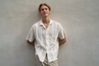 © Studio Sincère/Stocksy - Young Man Poses Casually Against a Textured Wall in Sunlight