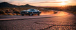 © homydesign - Vintage Muscle Car Driving on a Desert Highway at Sunset