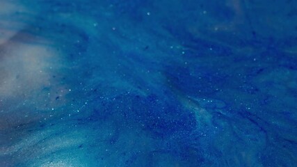 Wall Mural - Shiny spatter. Blue ink wave. Defocused pink color sparkling pigment wet particles pour on abstract acrylic vivid creative background.