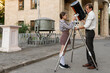 © Vagengeim - Girl assists teacher attaching telescope tube outdoors. Girl assists teacher while attaching telescope tube to tripod outdoors, focusing on teamwork, equipment setup, and astronomy education