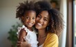 © David - African american happy woman smiling and hugging her daughter at home. High quality