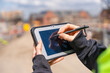 © Iryna - Close-up of woman construction manager useing rugged tablet to record data on construction site