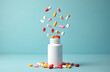 © Vadym - Pills, capsules fly from white bottle on blue surface. Healthcare, pharmaceutical concept. Variety of medicine in container used in medical treatment. Colorful drugs around container. Diet,