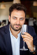 © Antonio Gravante - Man holding sparkling wine glass celebrating and tasting