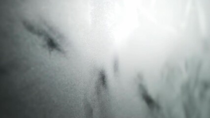 Wall Mural - Close-up slow pan across a frosted glass surface with soft, diffused light creating a textured, elegant, and abstract background diffused, graphic, obscured