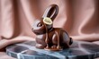 © Revana - Chocolate Easter bunny, drizzled with melted dark chocolate, sits on marble