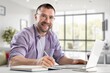 © BillionPhotos.com - Confident man working on laptop in modern in office