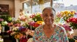 © IbragimovN - Elderly woman smiling in colorful flower shop display