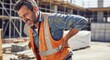 © Nazlykhan - Construction worker experiencing back pain at building site – workplace safety and health