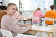© New Africa - Students taking exam at wooden table indoors, selective focus