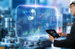 © panuwat - Smart technology industry control concept. Hands holding tablet on blurred automation machine as background