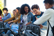 © Ladanifer - Young diverse students using a public bike sharing system