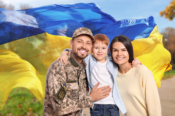 Wall Mural - happy military man and his family outdoors. double exposure with flag of ukraine