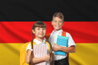 © New Africa - Children with backpacks and notebooks against flag of Germany. Language school