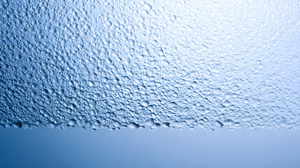 Wall Mural - Close-up of water droplets creating a textured surface in shades of blue.
