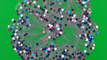 Wall Mural - Organic timelapse of iridescent glitter spreading and forming intricate patterns on a green screen background background, elegant, overlay